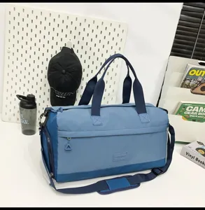 Large capacity travel duffel bag detail showing durable blue fabric, handles and strap.