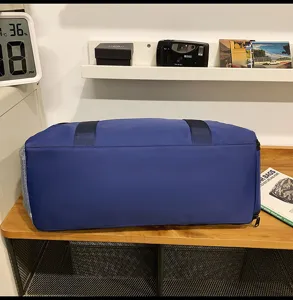Large capacity blue travel duffel bag with durable fabric, perfect for sports and gym.
