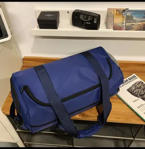 Blue large capacity travel duffel bag detail view, durable sports luggage with handles.