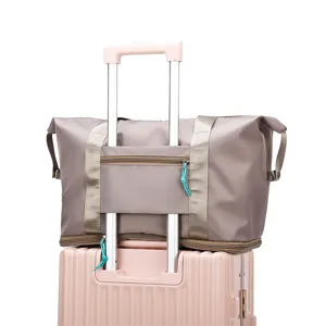 Travel duffel bag for women large capacity gym bag with luggage sleeve and expansion zipper.