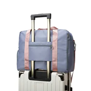 Large capacity travel duffel bag with trolley sleeve and pink straps for women fitness gym.