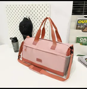 Pink and orange travel duffel bag, large capacity with sturdy handles for gym and sports.