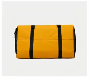 Detailed bottom view of waterproof yellow gym bag, showing durable fabric and sturdy straps.