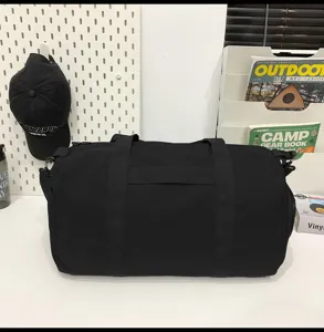 Detail view of the black travel duffel bag showcasing durable fabric and sturdy straps.