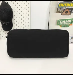 Black travel duffel bag detail view, large capacity luggage storage bag for trips.