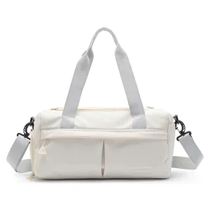 Lightweight nylon gym duffel bag with large capacity, dry-wet separation, and grey straps for travel.