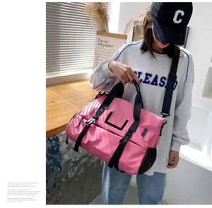 Detailed lifestyle close-up of the pink travel fitness duffel bag with side mesh pocket.