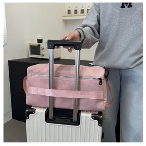 Large capacity pink travel duffel bag with trolley sleeve for short trips and gym fitness.