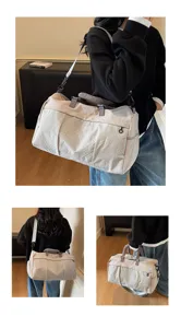 Large capacity grid travel duffel bag detail, showing shoulder strap and durable fabric texture.