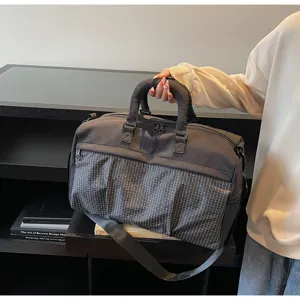 Large capacity gym duffel bag for travel and fitness with stylish grid pocket design.