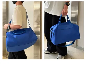 Large capacity blue travel duffel bag for fitness, waterproof weekender bag with handles and strap.