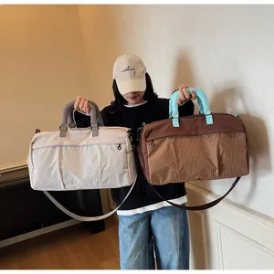 Large capacity gym travel bag for women men, stylish waterproof sports duffel bag for outdoor use.