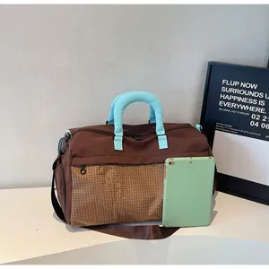 Large capacity travel duffel bag with gym compartments and comfortable blue handles.