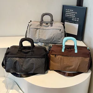 Large capacity travel duffel bag for fitness and sports, stylish waterproof weekender bag.