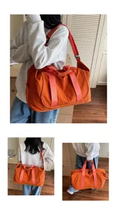Detail view of orange oxford cloth travel duffel bag showing straps and multi-use.