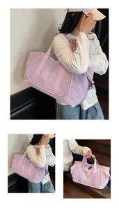 Detail showcasing lightweight light purple oxford gym duffel bag with handles and strap details.