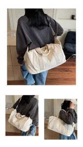 Detail view of lightweight canvas duffel bag, casual travel fitness bag in daily use scenario.