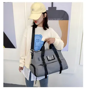 Gray waterproof gym bag with independent shoe compartment and wet dry separation for travel.