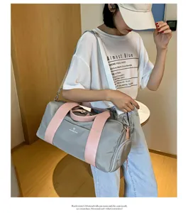 Detailed view of large capacity gym travel duffel bag in stylish gray and pink color.
