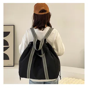 Black travel backpack with striped straps, large capacity versatile canvas shoulder bag for women.