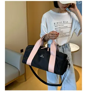 Large capacity gym duffel bag with shoe compartment, black and pink travel sports bag for women.