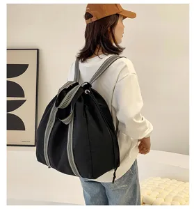 Large capacity black oxford cloth backpack with stylish striped straps for travel and casual wear.