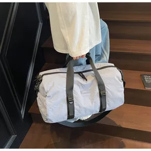Casual travel duffel bag detail, minimalist waterproof shoulder bag with sturdy straps.