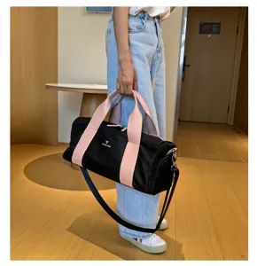 Large capacity gym duffel bag for sports and travel with pink handles and shoulder strap.