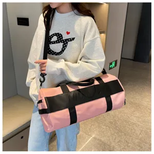 Pink sports duffel bag detail showcasing large capacity, durable straps, and stylish design.