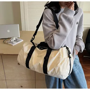 Detailed view of casual travel duffel bag showing durable shoulder strap and sturdy buckles.