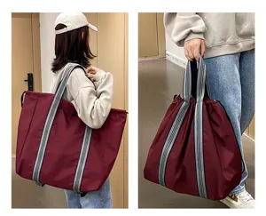 Detail view of large capacity oxford travel bag showing multi-use straps and side design.