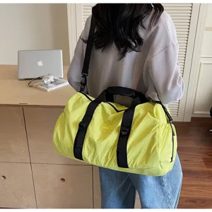 Casual travel duffel bag in bright yellow, perfect for gym and sports fitness with crossbody strap.