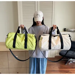 Detailed view of large capacity waterproof travel duffel bag in dual colors for sports gym fitness.