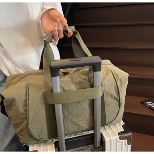 Lightweight travel duffel bag for gym and outdoor sports, features trolley sleeve and durable oxford cloth.