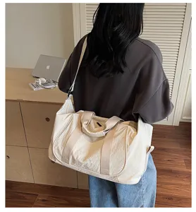 Detailed back view of a beige nylon travel duffel bag for yoga and fitness training.
