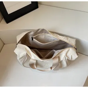 Open gym duffel bag interior detail, showing large capacity and zipper pocket structure.