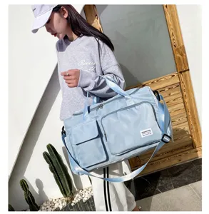 Large capacity gym duffel bag with shoe compartment, stylish blue travel bag for men and women.