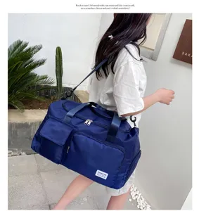 Detailed view of large capacity blue oxford travel gym bag featuring shoe compartment.
