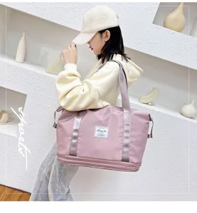 Detail shot of pink travel duffel bag with double-layer expansion and luggage sleeve.