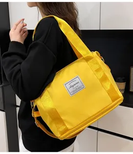 Small yellow gym bag for women, expandable waterproof fitness travel shoulder crossbody bag.