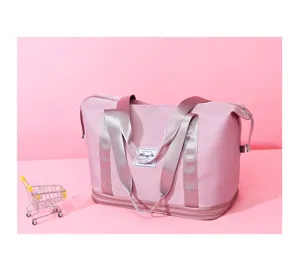 Detailed view of the pink travel duffel bag showing its dual-layer expansion design and handles.