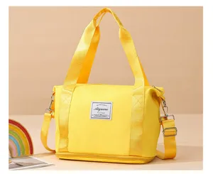 Small fitness travel duffel bag with shoulder strap and bottom compartment for daily use.