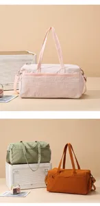 Detailed view of large capacity sports duffel bag with handles and adjustable shoulder strap.