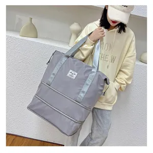 Grey expandable gym travel bag for women, large capacity waterproof weekender carry-on tote.