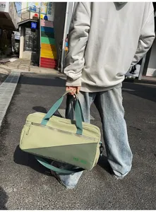 Outdoor lifestyle detail view of the waterproof sports duffel bag with dual handles and straps.