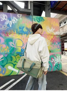 Large capacity sports duffel bag detail view, stylish two-tone travel bag for gym and yoga.
