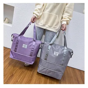Expandable travel duffel bag with dry wet separation and luggage sleeve for fitness.