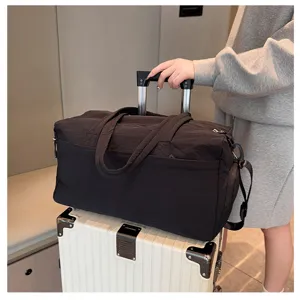 Large capacity black travel duffel bag with luggage sleeve for gym sports and weekend trips.