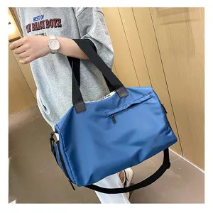 Blue oxford fitness gym bag for women with shoulder strap and shoe compartment storage.