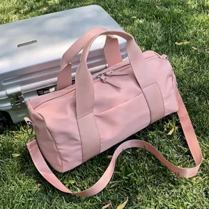 Pink travel duffel bag with dry wet separation and shoulder strap for gym sports fitness.